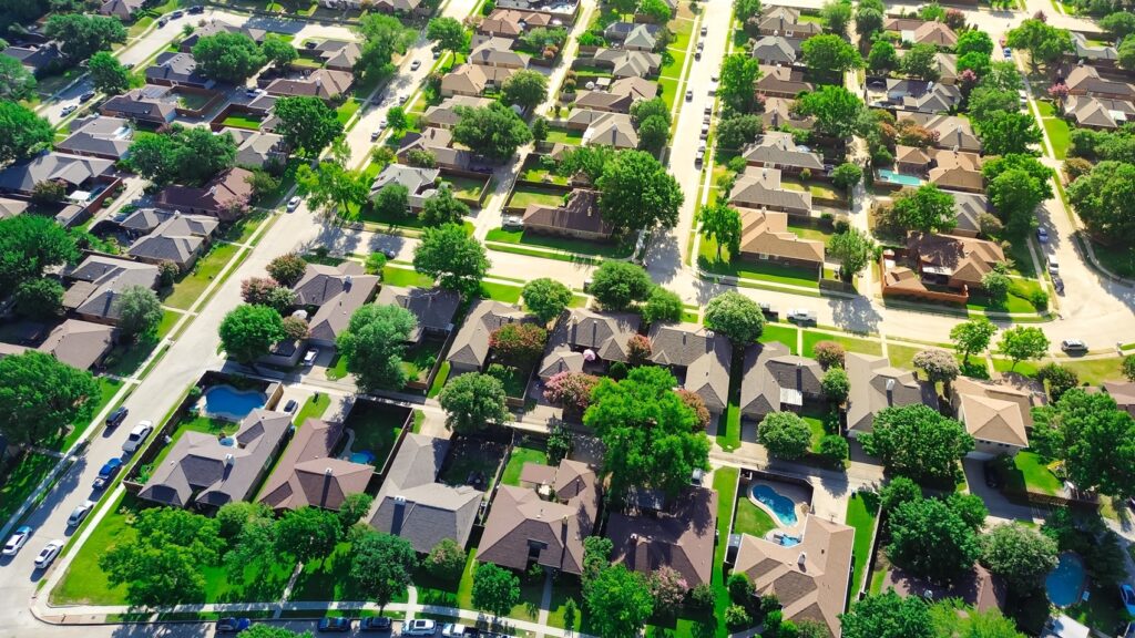 A bird's eye view of a suburban neighborhood with nice houses and multiple cul-de-sacs.